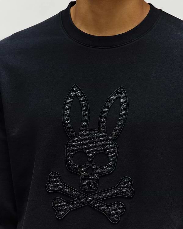 Mens Gabin Textured Crew, a black classic-fit sweatshirt featuring a large, tonal black embroidered and textured Psycho Bunny skull logo prominently on the chest, crafted from soft jersey.