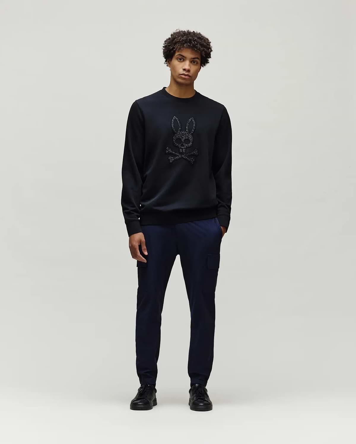 Mens Gabin Textured Crew black classic fit crewneck sweatshirt featuring a large, textured black Psycho Bunny skull and crossbones logo centrally on the chest.