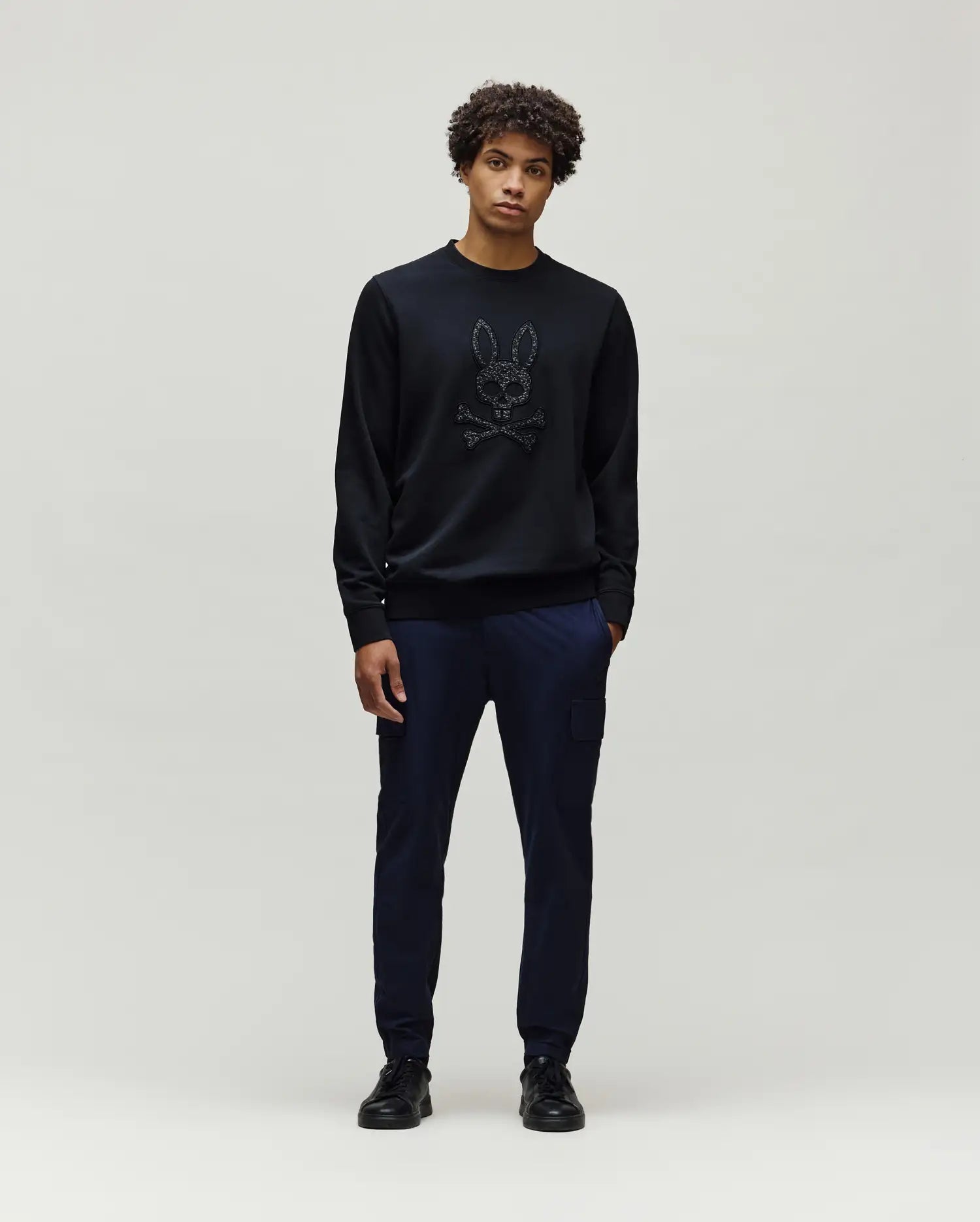 Mens Gabin Textured Crew black classic fit crewneck sweatshirt featuring a large, textured black Psycho Bunny skull and crossbones logo centrally on the chest.