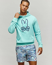 Mens Gage Patch Hoodie, an aqua classic fit French terry hoodie featuring a large dark blue embroidered Psycho Bunny skull logo on the chest and a front kangaroo pocket.