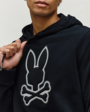 Mens Gage Patch Hoodie, black classic fit hoodie in soft jersey knit, featuring a large central white Psycho Bunny skull logo patch with detailed stitching and branded drawstring aglets.