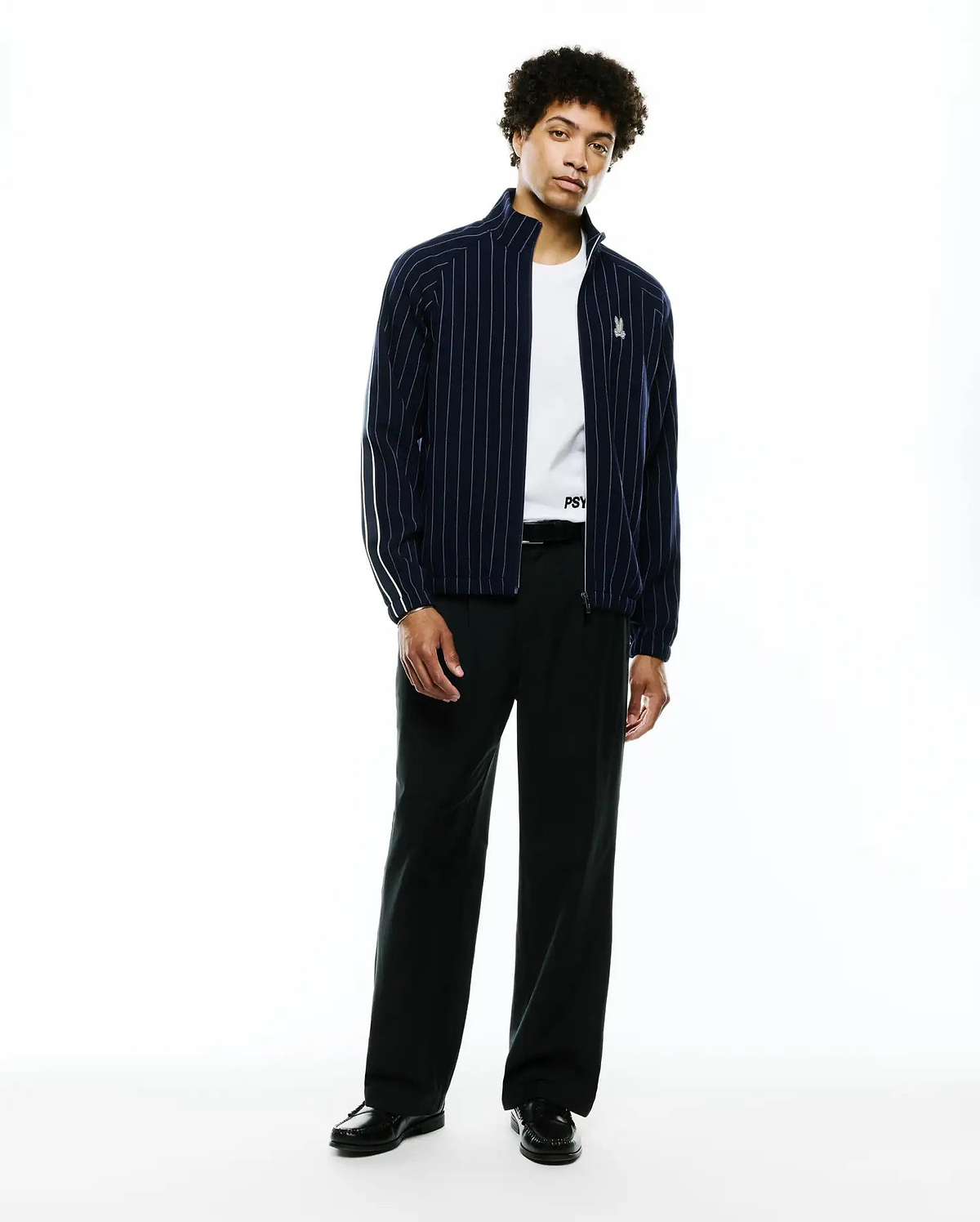 Mens Harland Double Weave Chalk Stripe Track Jacket in navy with white vertical pinstripes, a full zip, stand collar, and a small embroidered Psycho Bunny skull logo on the left chest, featuring white accent stripes on the sleeves. (5)