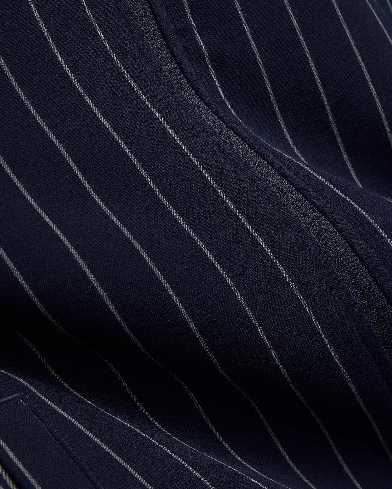 Mens Harland Double Weave Chalk Stripe Track Jacket in navy, featuring subtle white pinstripes and a textured zipper, highlighting its premium double weave fabric. (7)