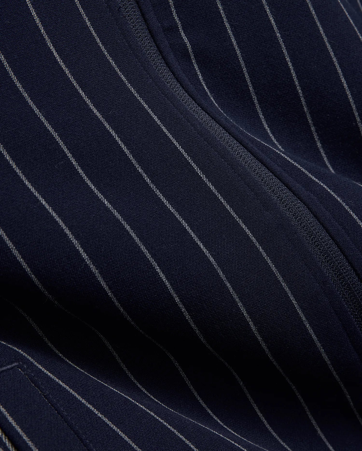 Mens Harland Double Weave Chalk Stripe Track Jacket in navy, featuring subtle white pinstripes and a textured zipper, highlighting its premium double weave fabric. (7)