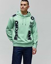 Mens Toby Oversized Hoodie in mint green french terry, featuring large navy blue PSYCHO BUNNY text with white outlines vertically on the front and a bunny skull logo on the chest.