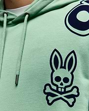 Mens Toby Oversized Hoodie in mint green jersey, featuring a large navy Psycho Bunny skull logo on the chest, partial circular graphic, and branded drawstrings with metal tips.