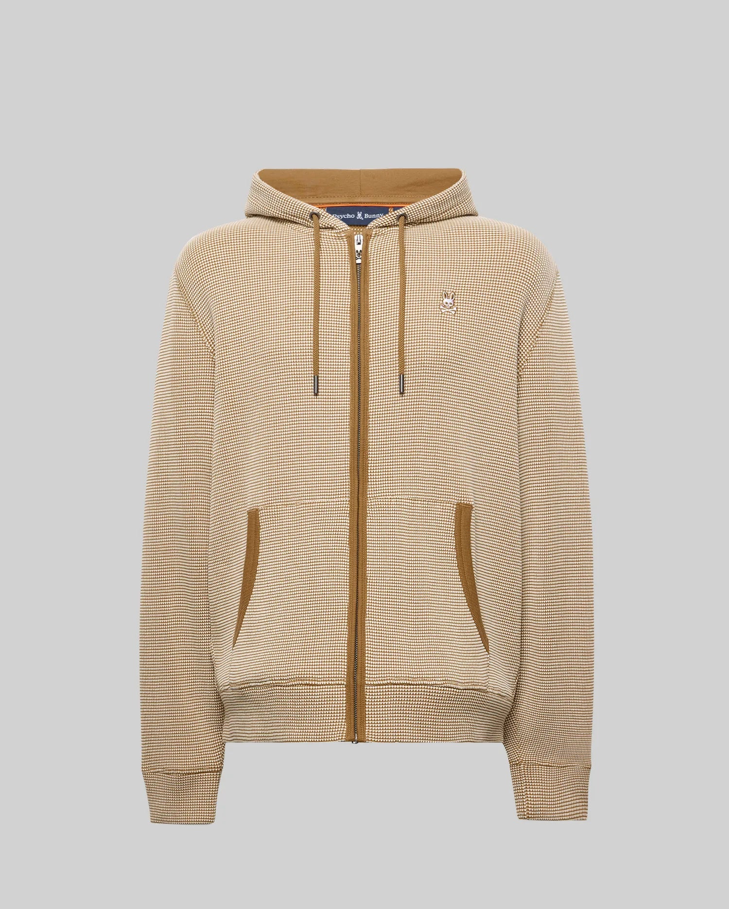 MENS MAXTON WAFFLE FULL ZIP HOODIE in beige waffle knit with brown accents, featuring a full zip, drawstring hood, front pockets, and a small embroidered Psycho Bunny skull logo on the left chest.