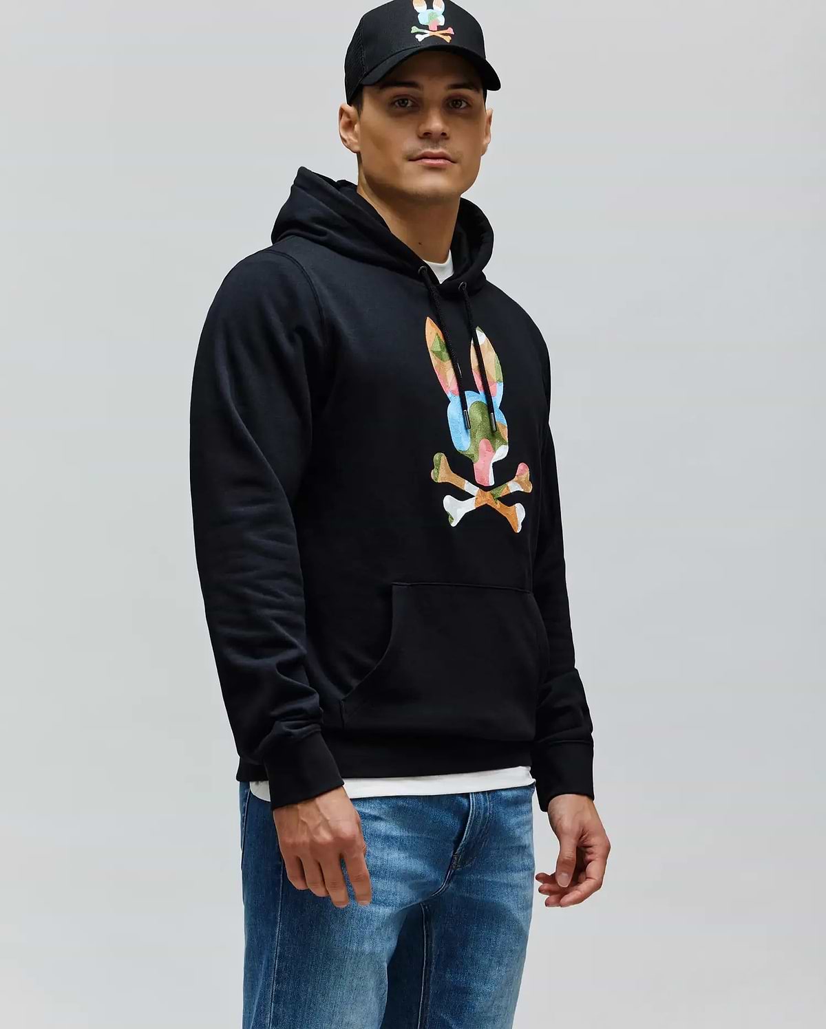 Mens Ara Hoodie, a black classic fit French terry hoodie featuring a large, vibrant multi-color Psycho Bunny skull and crossbones logo on the chest, with a drawstring hood and kangaroo pocket.