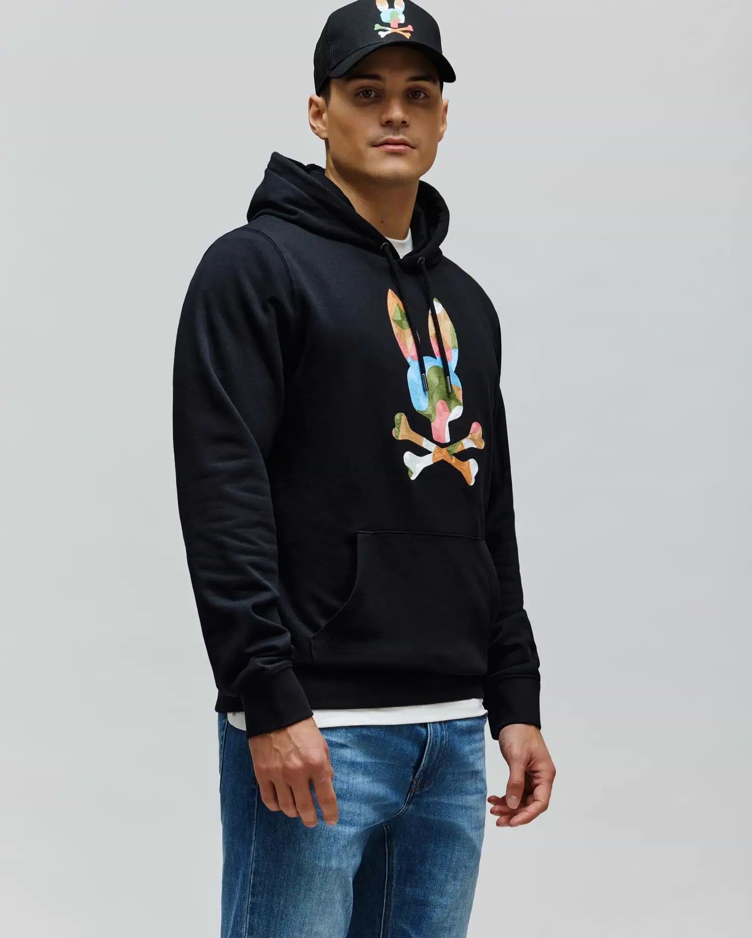 Mens Ara Hoodie, a black classic fit French terry hoodie featuring a large, vibrant multi-color Psycho Bunny skull and crossbones logo on the chest, with a drawstring hood and kangaroo pocket.