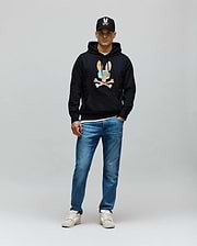 Mens Ara Hoodie, a black classic fit French terry hoodie featuring a large, colorful camouflage Psycho Bunny skull logo with white crossbones on the chest, plus a front pouch pocket and drawstring hood.