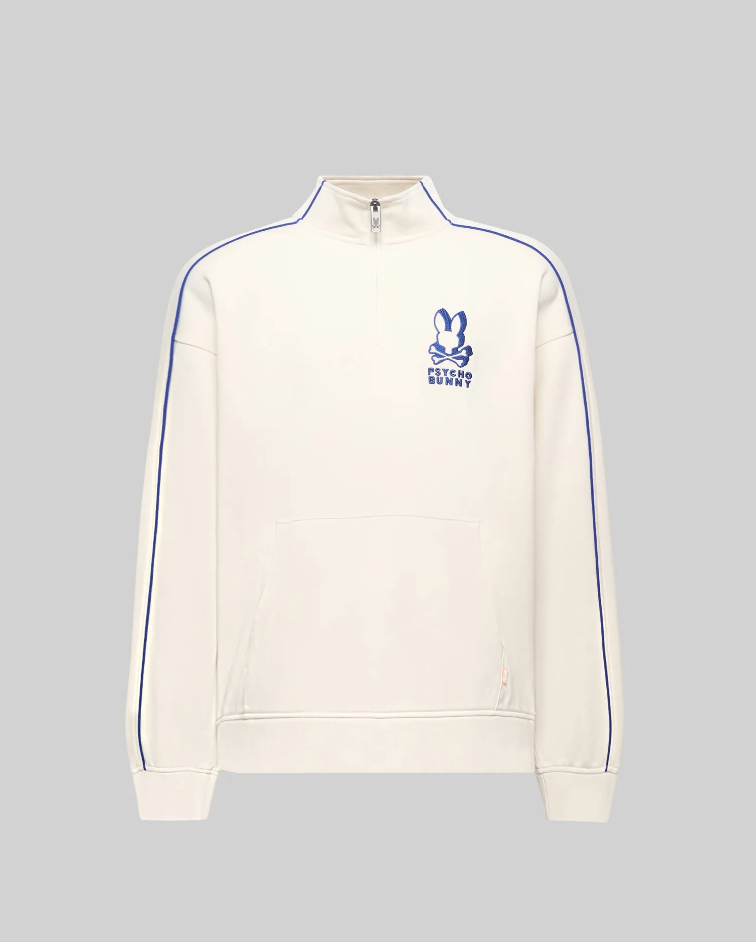 Mens Toby 1/4 Zip in cream French terry, relaxed fit, with blue vertical sleeve piping, a kangaroo pocket with orange tag, and an embroidered blue Psycho Bunny logo on the left chest.
