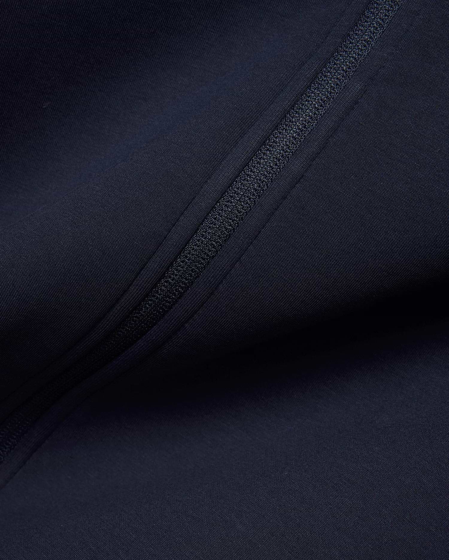 Mens Jaydon Track Jacket in deep navy, crafted from a smooth, performance-ready knit fabric, featuring a sleek, tonal full-zip closure for a refined streetwear look. (6)