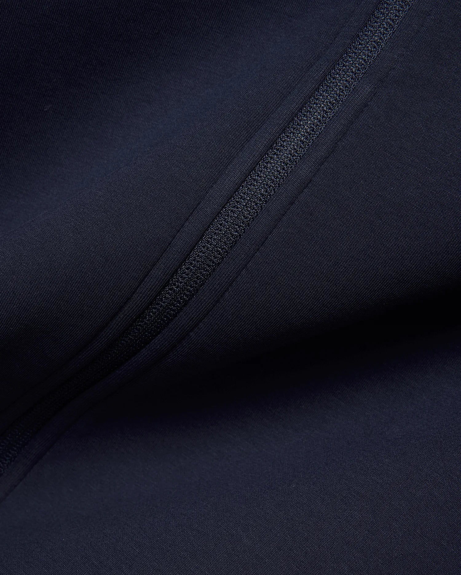 Mens Jaydon Track Jacket in deep navy, crafted from a smooth, performance-ready knit fabric, featuring a sleek, tonal full-zip closure for a refined streetwear look. (6)