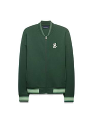Mens Jaydon Track Jacket in forest green, featuring a full-zip closure, classic fit, smooth knit fabric, and a small embroidered white Psycho Bunny skull logo on the left chest. Ribbed collar and cuffs have light green stripes.