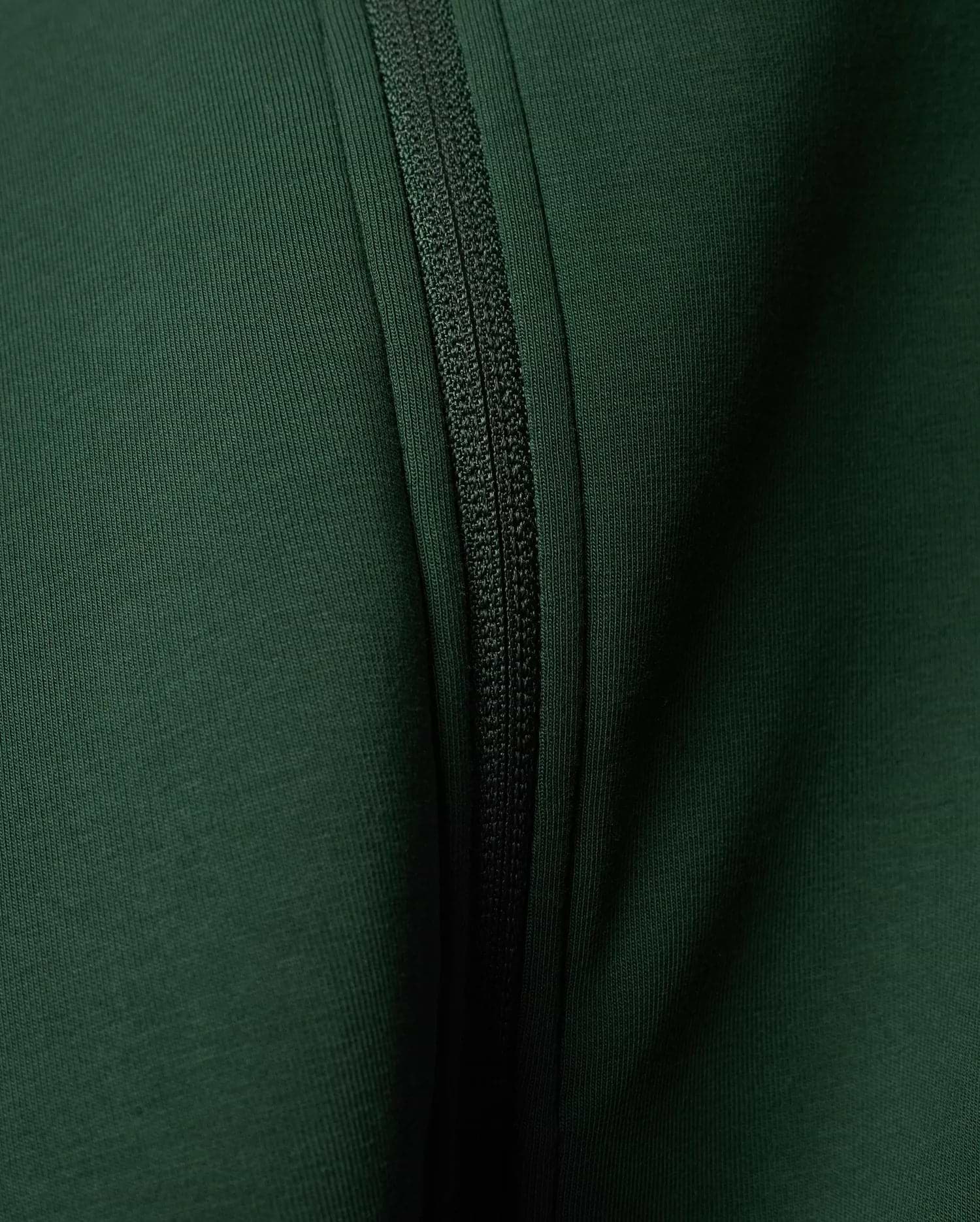 Mens Jaydon Track Jacket in a rich, deep forest green, featuring a prominent tonal zipper closure and a finely textured ribbed knit fabric.
