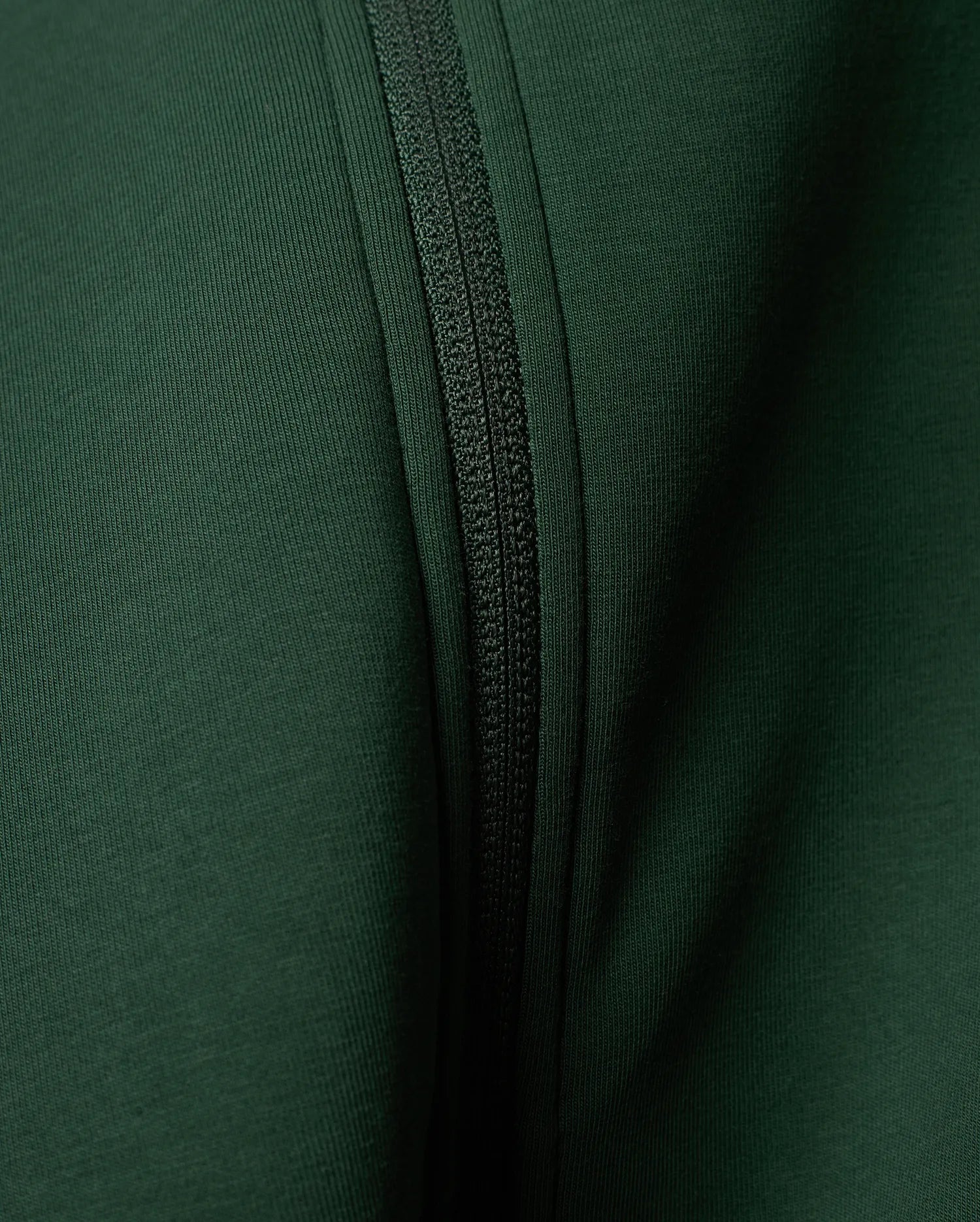 Mens Jaydon Track Jacket in a rich, deep forest green, featuring a prominent tonal zipper closure and a finely textured ribbed knit fabric.