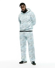 Men's Alfie All-Over Print Hoodie, a relaxed fit light blue and grey digital camo print hoodie with white drawstrings and a small embroidered white Psycho Bunny skull logo on the left chest. (1)
