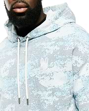Men's Alfie All-Over Print Hoodie in light blue, white, and grey pixelated digital camo print, featuring a classic fit, soft knit fabric, and an embroidered white Psycho Bunny skull logo on the left chest with white drawstrings. (3)