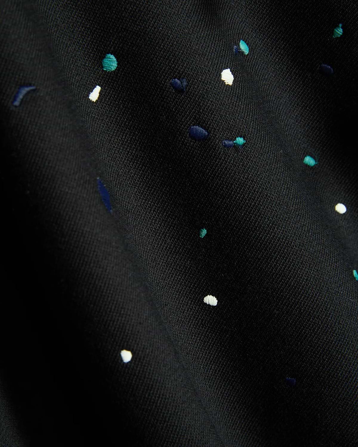 Mens Malcom Splatter Hoodie in black, featuring a soft knit fabric with an embroidered multi-color splatter pattern in white, teal, and dark blue.