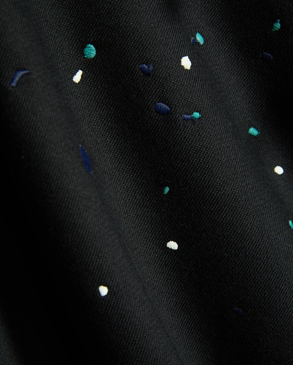 Mens Malcom Splatter Hoodie in black, featuring a soft knit fabric with an embroidered multi-color splatter pattern in white, teal, and dark blue.