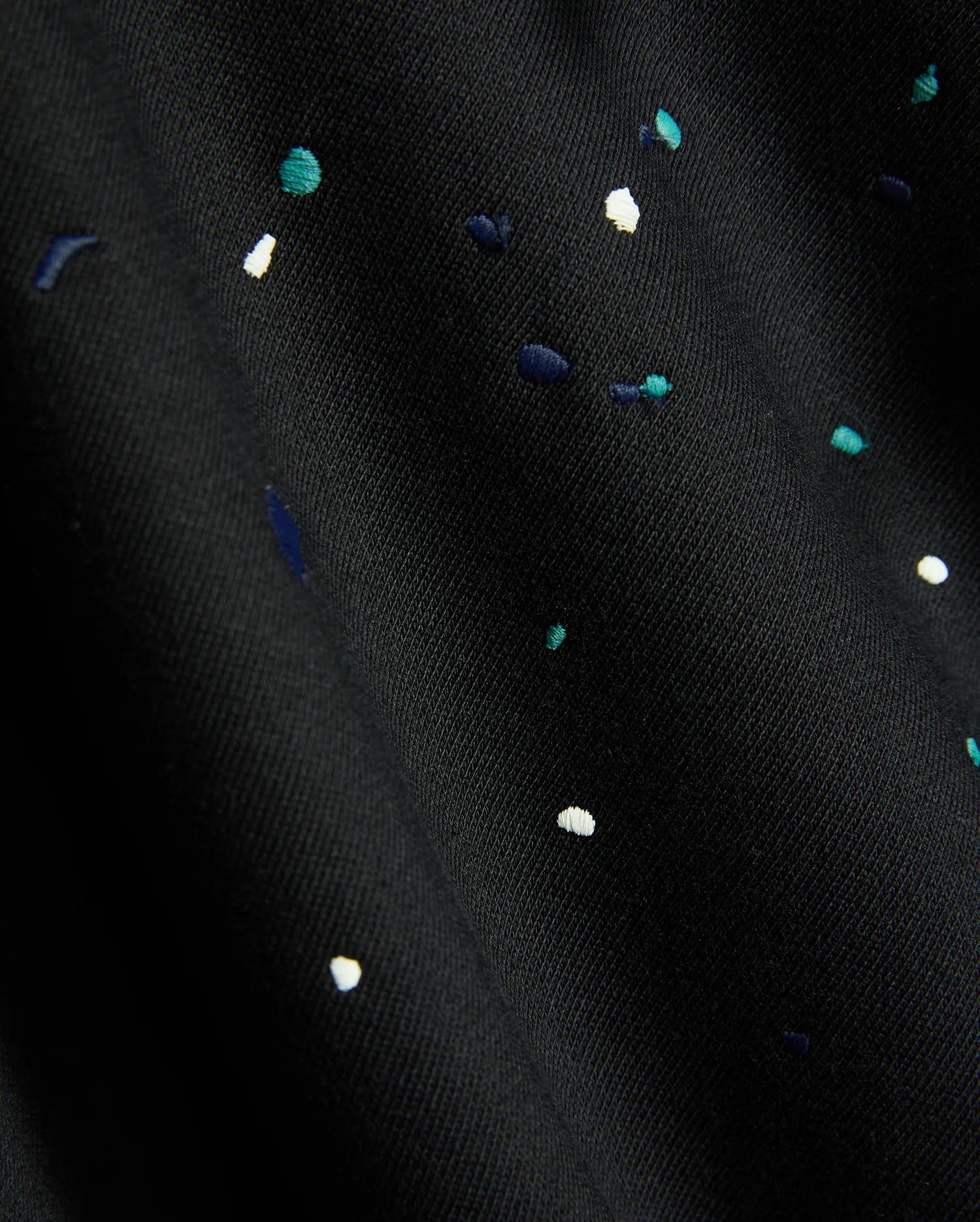 Mens Malcom Splatter Hoodie in black, featuring a soft knit fabric with an embroidered multi-color splatter pattern in white, teal, and dark blue.