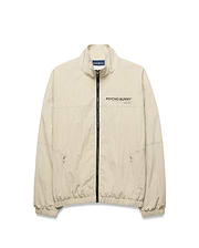 Light beige Mens Alder Nylon Jacket, a classic fit crinkled nylon jacket with full black zip, stand collar, zippered side pockets, elastic cuffs/hem, and a black Psycho Bunny chest logo.