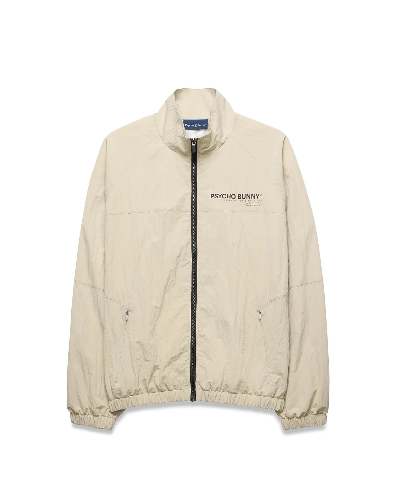 Light beige Mens Alder Nylon Jacket, a classic fit crinkled nylon jacket with full black zip, stand collar, zippered side pockets, elastic cuffs/hem, and a black Psycho Bunny chest logo.
