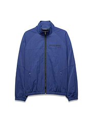 Mens Alder Nylon Jacket, a royal blue full-zip jacket with a crinkled texture, features a stand collar, elastic cuffs/hem, zippered pockets, and a large black PSYCHO BUNNY® DESIGNED FOR DISRUPTION text logo on the chest. (5)