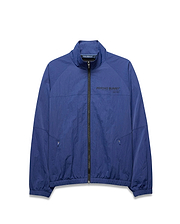 Mens Alder Nylon Jacket, a royal blue full-zip jacket with a crinkled texture, features a stand collar, elastic cuffs/hem, zippered pockets, and a large black PSYCHO BUNNY® DESIGNED FOR DISRUPTION text logo on the chest. (5)