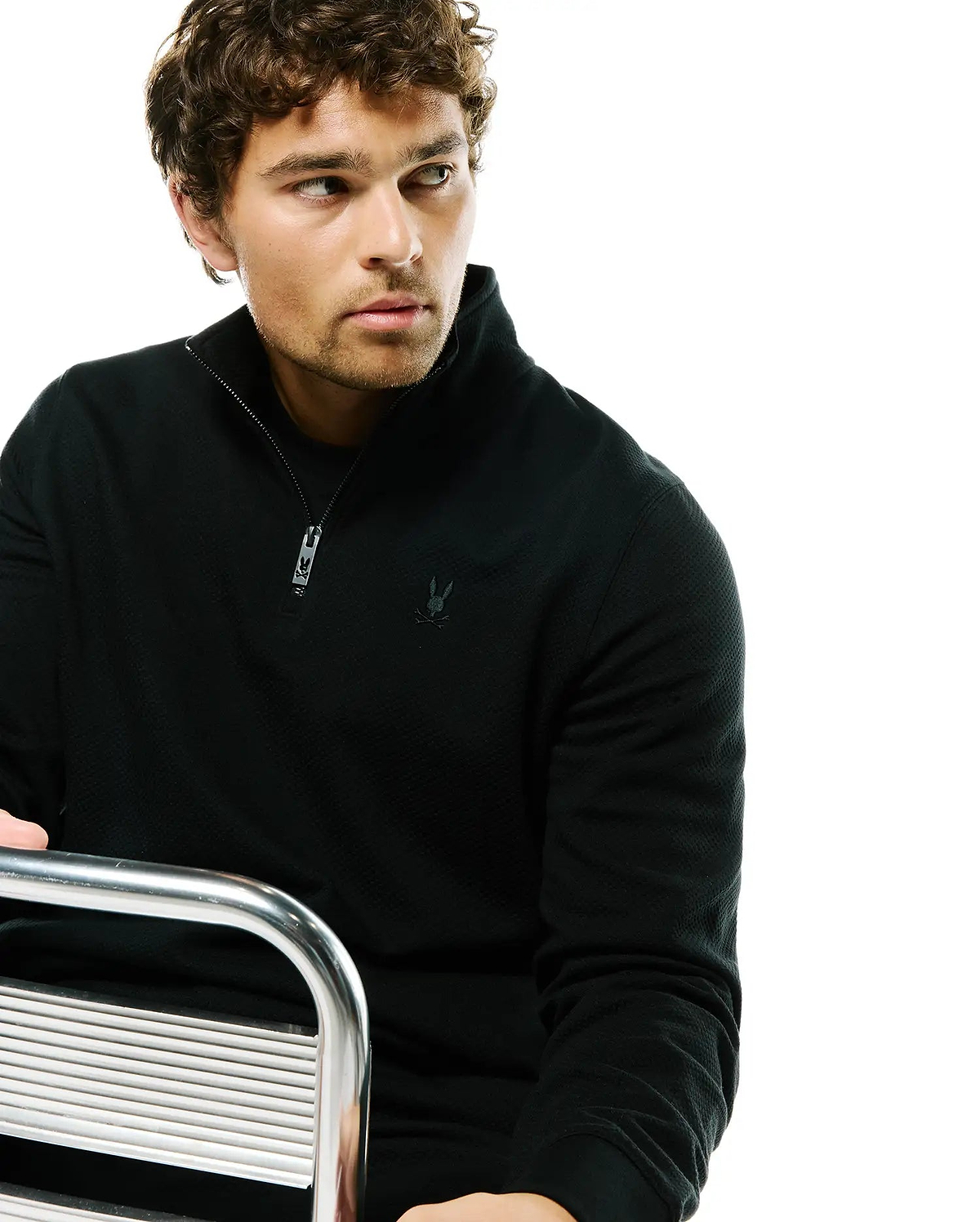 Mens Marc Textured 1/4 Zip in black, featuring a classic fit, textured knit fabric, quarter zip closure with custom pull, and a small tonal embroidered Psycho Bunny skull logo on the left chest.