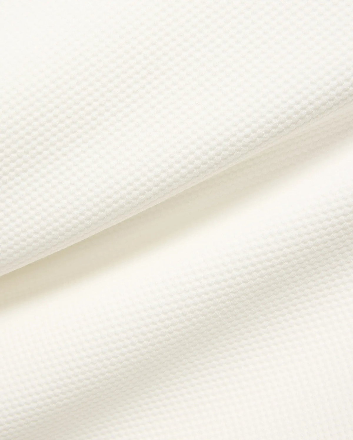 Mens Marc Textured 1/4 Zip in cream, showcasing a premium, subtly textured pique knit fabric with a fine, raised geometric pattern.