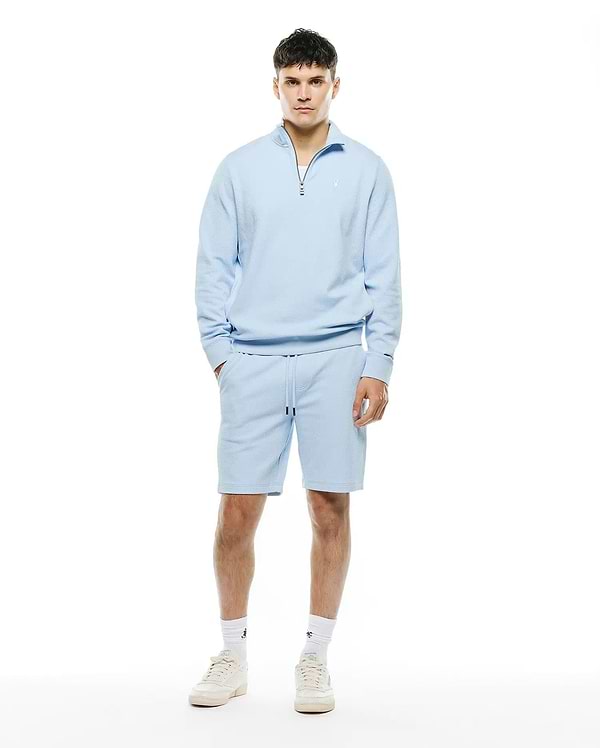 Light blue Mens Marc Textured 1/4 Zip and matching textured shorts, featuring a relaxed fit, silver quarter-zip, and small embroidered Psycho Bunny skull logo on the left chest.