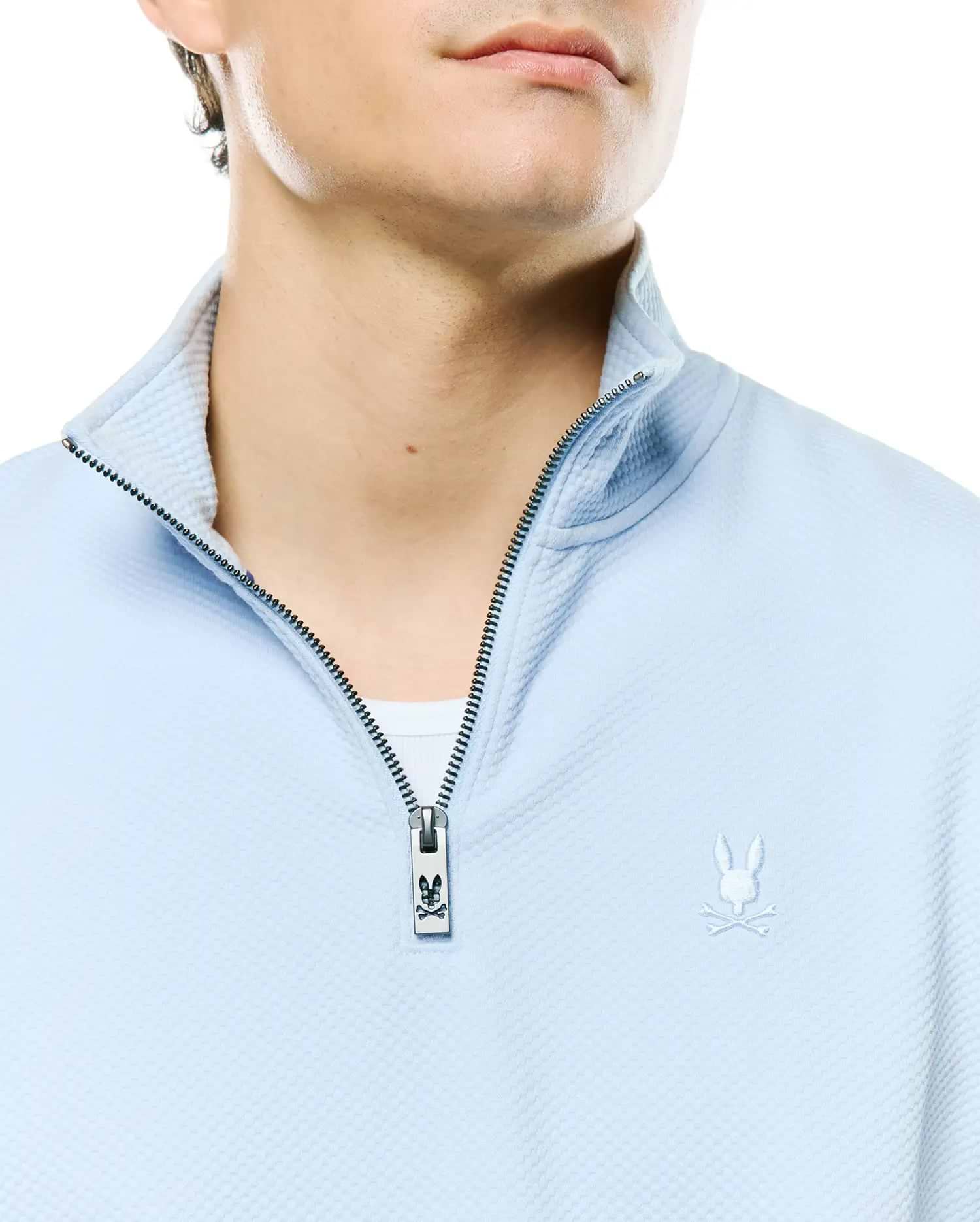 Mens Marc Textured 1/4 Zip, light blue waffle knit, with a silver zipper featuring a Psycho Bunny logo pull and an embroidered white bunny skull logo on the left chest.