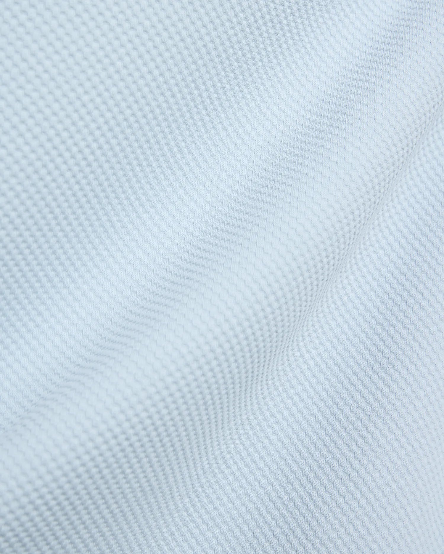 Mens Marc Textured 1/4 Zip in a soft light blue, crafted from a premium, refined pique-textured fabric with subtle folds, reflecting Psycho Bunny's elevated streetwear aesthetic.