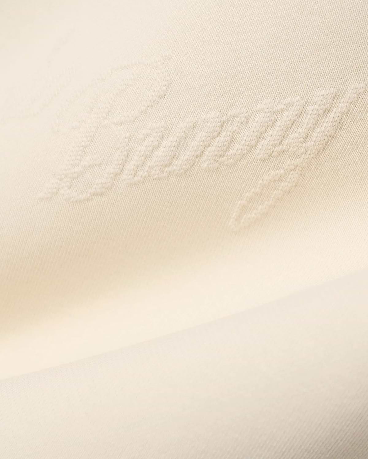 Mens Cedrick All Over Jacquard Crew in creamy off-white, featuring a subtle raised jacquard knit pattern of the word Bunny throughout the fabric.