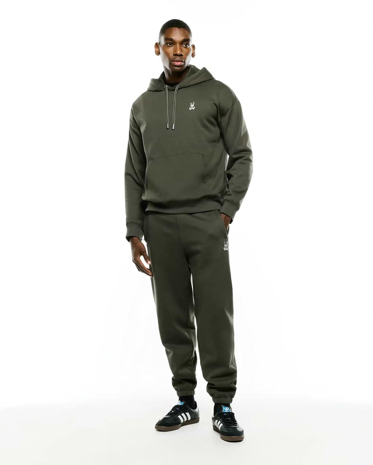 Mens Terrence Brushed Fleece Hoodie in olive green, featuring a relaxed fit, soft brushed fleece, white drawstrings, kangaroo pocket, and a small embroidered white Psycho Bunny skull logo on the left chest.