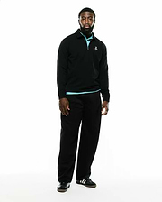 Men's Samson Quarter-Zip Sweater, a classic fit black smooth knit quarter-zip with a collared neckline, light blue accent at the collar and hem, and a small embroidered white Psycho Bunny skull logo on the left chest. (1)
