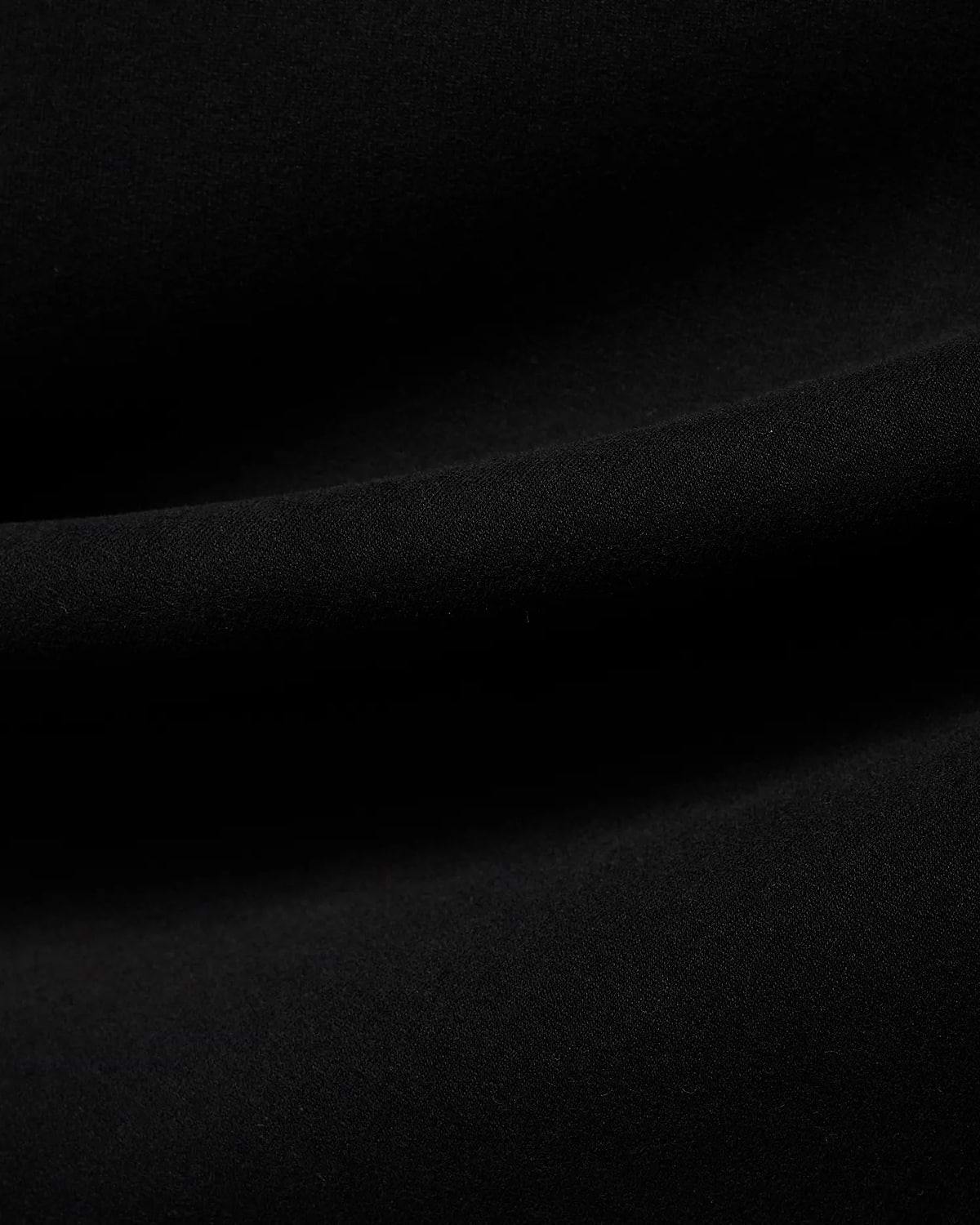 Men's Samson Quarter-Zip Sweater in classic black, crafted from a soft, smooth jersey knit fabric, showcasing its premium texture with subtle folds. (6)