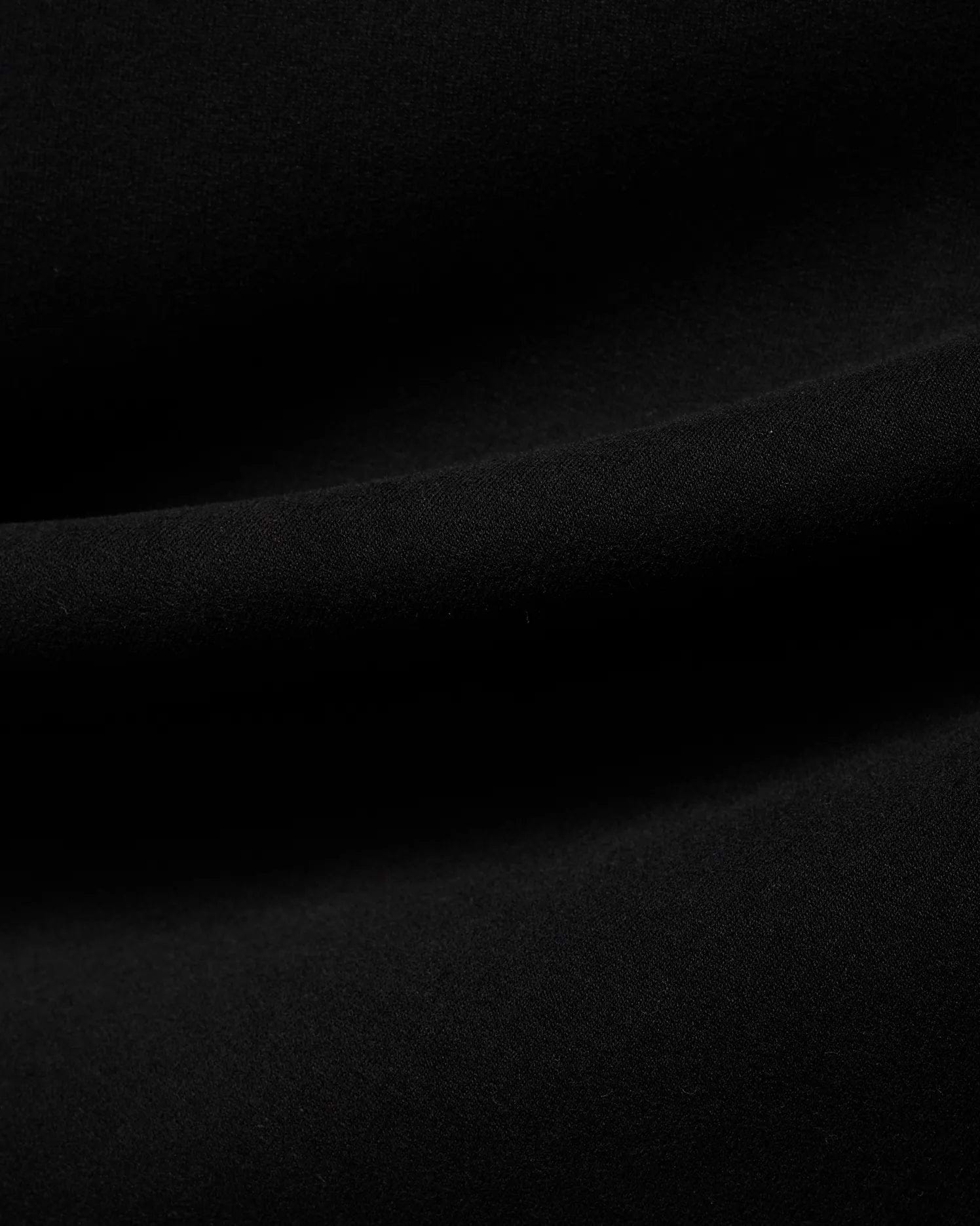 Men's Samson Quarter-Zip Sweater in classic black, crafted from a soft, smooth jersey knit fabric, showcasing its premium texture with subtle folds. (6)