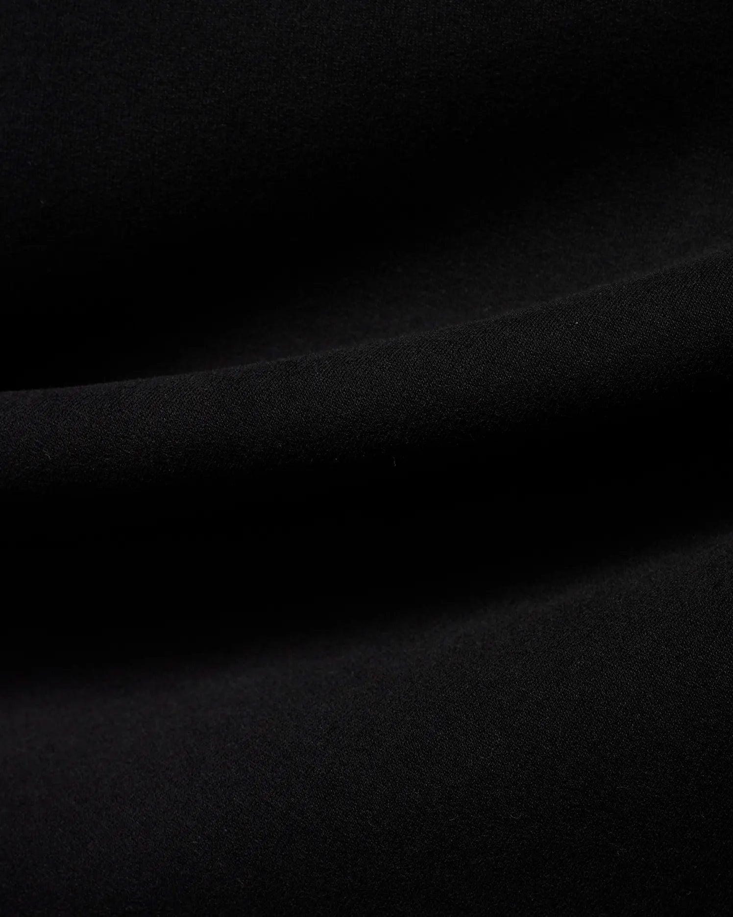 Men's Samson Quarter-Zip Sweater in classic black, crafted from a soft, smooth jersey knit fabric, showcasing its premium texture with subtle folds. (6)