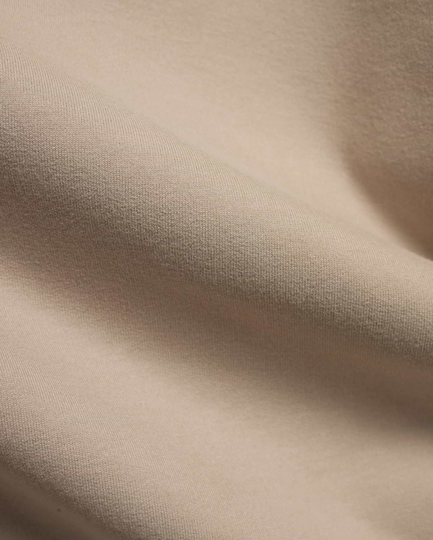 MEN'S SAMSON QUARTER-ZIP SWEATER in a premium, soft beige knit fabric, featuring a subtle vertical texture and gentle folds, indicating a comfortable, refined style. (6)