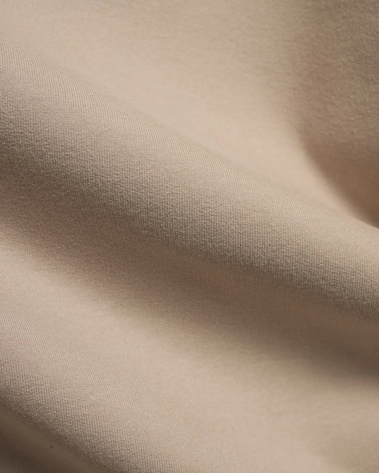 MEN'S SAMSON QUARTER-ZIP SWEATER in a premium, soft beige knit fabric, featuring a subtle vertical texture and gentle folds, indicating a comfortable, refined style. (6)