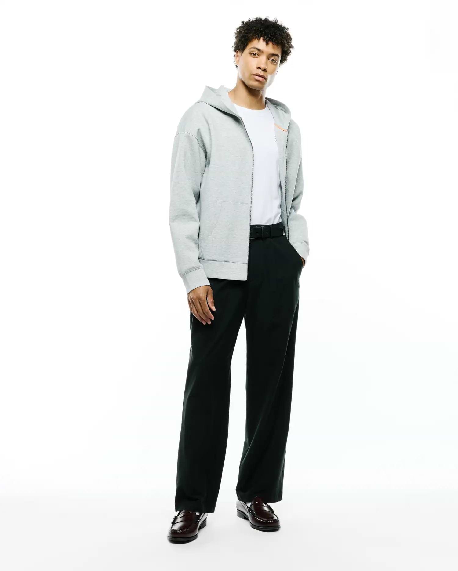 Mens Jonathan Zip Hoodie, a relaxed fit heather grey French terry full-zip hoodie featuring an orange zipper pull, drawstring hood, kangaroo pockets, and a small embroidered Psycho Bunny skull logo on the left chest. (4)