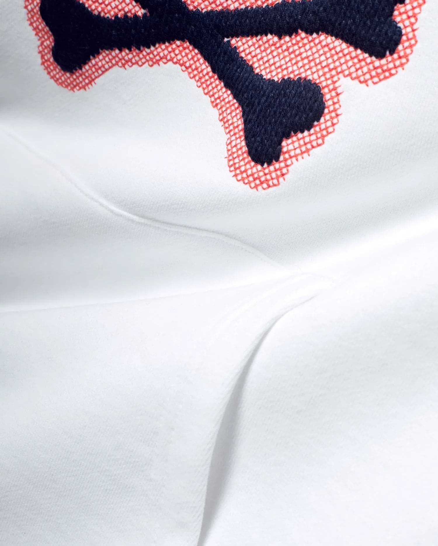 White Men's Samson Cotton Hoodie featuring a large, detailed embroidered Psycho Bunny skull logo with navy blue outline and red crosshatch fill on soft cotton jersey fabric. (6)