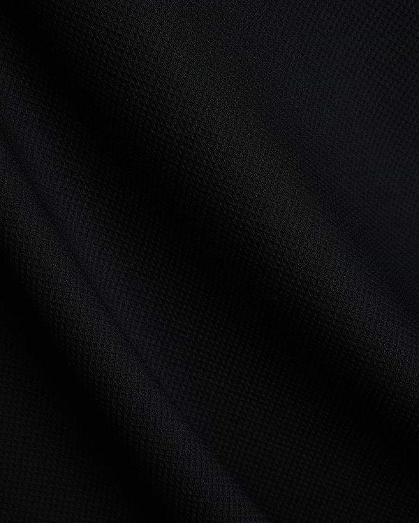 Mens Tomas Waffle Hoodie, a luxurious black waffle knit fabric, showcasing the premium texture and quality expected from Psycho Bunny refined streetwear. (6)