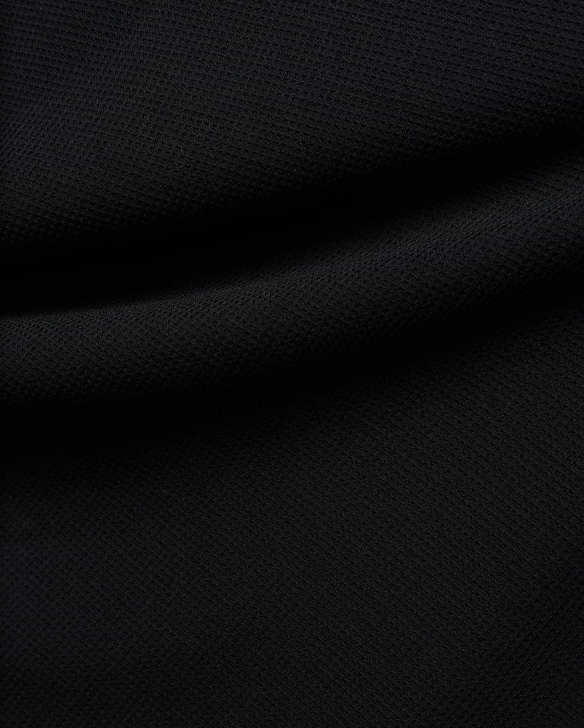 Premium black Tomas Waffle 1/4 Zip, showcasing its rich, deep black fabric with a prominent, textured waffle knit pattern and soft, flowing folds, embodying Psycho Bunny's refined streetwear. (6)