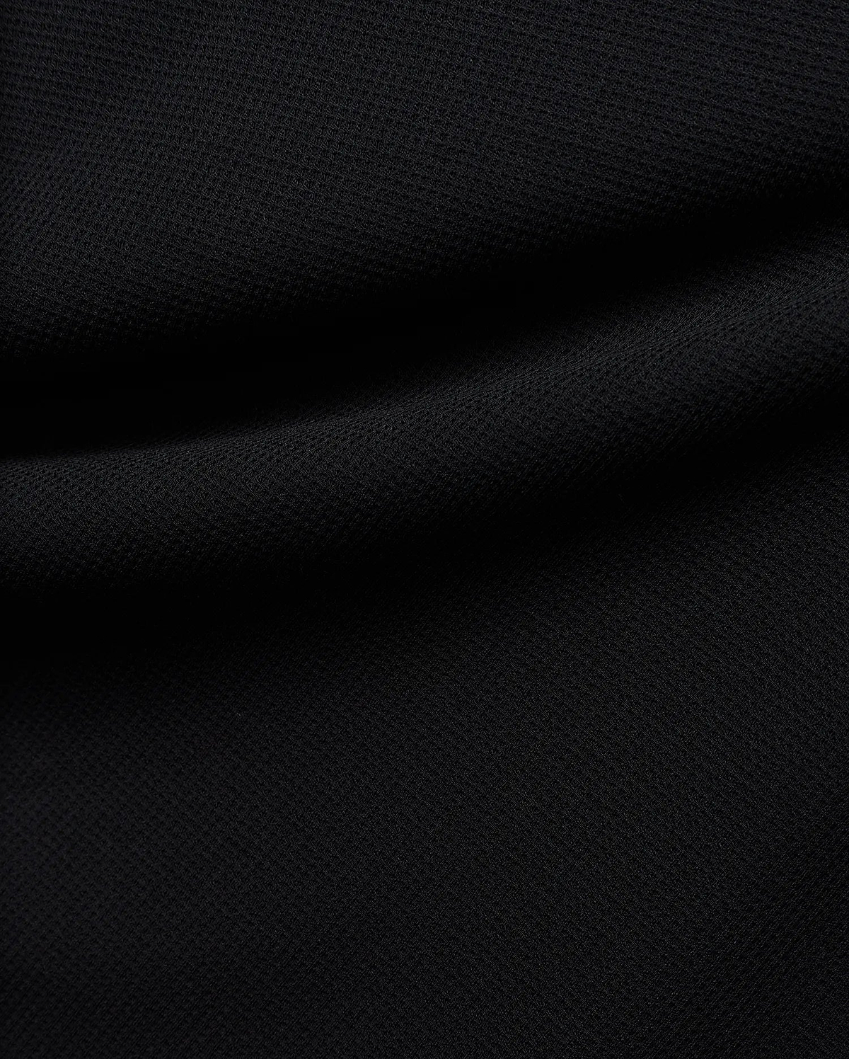 Premium black Tomas Waffle 1/4 Zip, showcasing its rich, deep black fabric with a prominent, textured waffle knit pattern and soft, flowing folds, embodying Psycho Bunny's refined streetwear. (6)