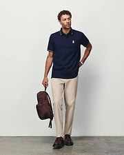 Mens Jaydon Pique Polo in navy, featuring a classic fit, pique texture, and small embroidered Psycho Bunny skull logo on the left chest with gold tipping on the collar and cuffs.
