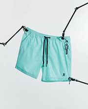 Mens Samos Hydrochromic Printed Swim Trunk 6 in aqua with a subtle hydrochromic bunny skull pattern, black Psycho Bunny drawstrings, and a small embroidered bunny skull logo.