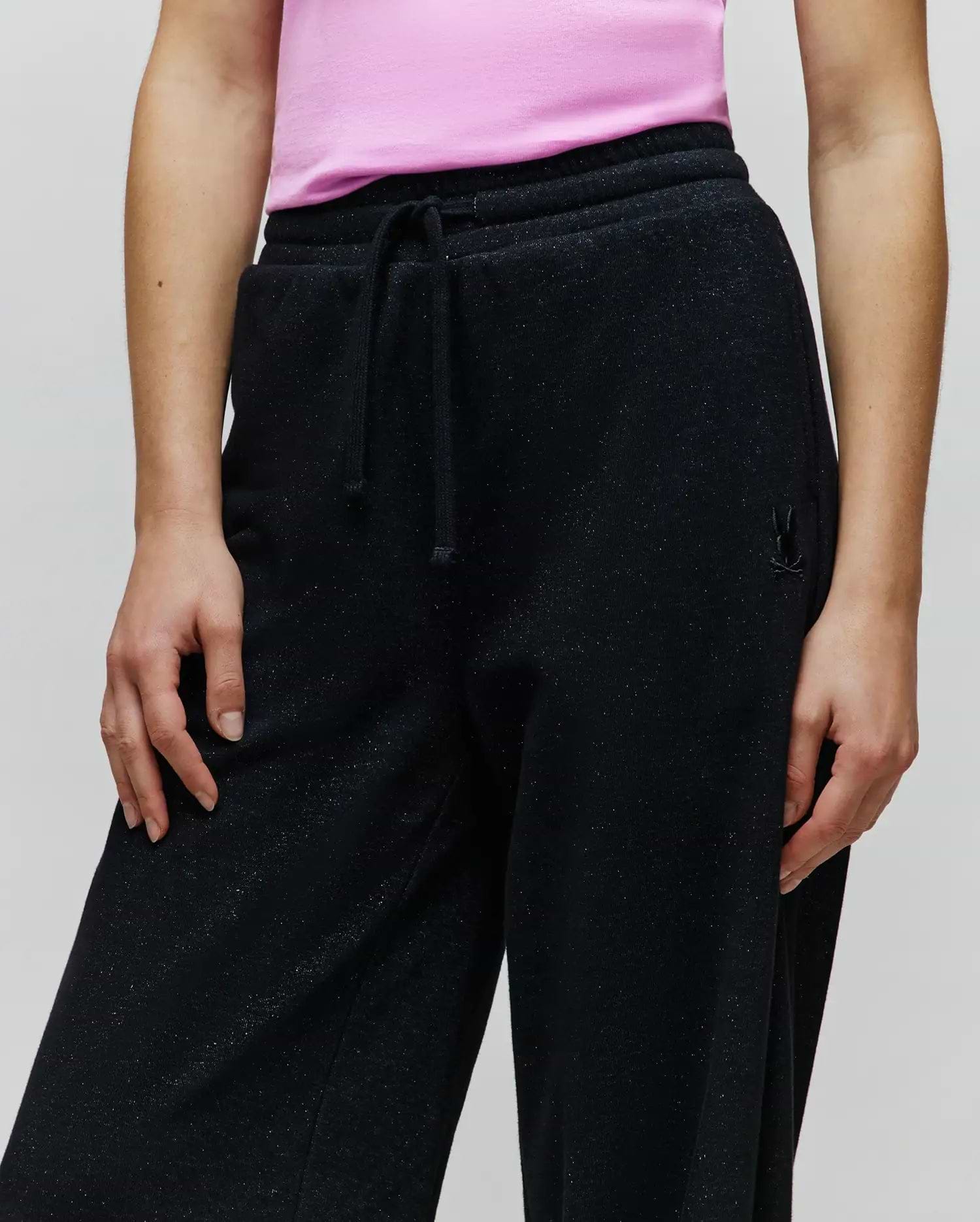 Womens Jules Lurex Sweatpant, black relaxed fit with subtle silver lurex sparkle, featuring a drawstring waist and a small tonal embroidered Psycho Bunny skull logo on the right hip.
